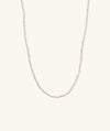 Micro Pearl Necklace: Handcrafted 14k gold necklace featuring a delicate string of freshwater pearls. Ideal for enhancing any outfit with its elegant simplicity.